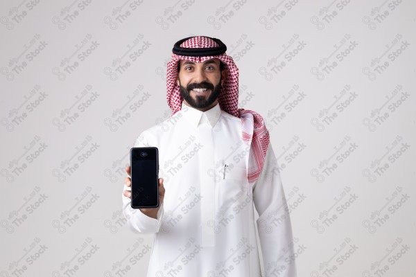 Portrait of a Saudi man holding an automatic payment device and making different expressions