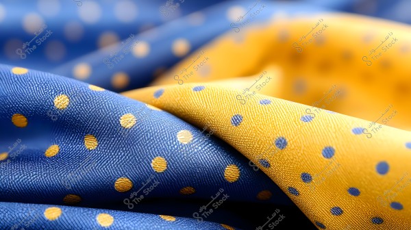 Image of fabric decorated with polka dots. The image shows two pieces of fabric, one blue with yellow dots, and the other yellow with blue dots. The fabrics are wavy and appear with detailed texture and a prominent color contrast.