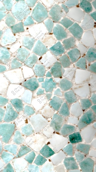 An image of a mosaic composed of irregularly shaped tiles in shades of white and light blue. The tiles are randomly arranged, creating an interlocking pattern on a white background.