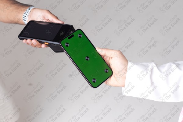 Portrait of a Saudi man holding a card and making automatic payments on a white background