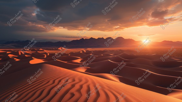 A scenic landscape image of a desert at sunset, featuring expansive, rolling sand dunes bathed in warm sunlight. The sky is filled with layers of clouds that appear orange and golden due to the evening light. In the distance, there is a dark silhouette of a mountain range, adding depth to the landscape.
