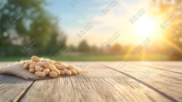 ** An image showing a pile of almonds placed on a piece of burlap on a wooden surface. In the background, there is a blurred natural landscape with the sun rising, casting golden rays across the horizon and creating a warm and serene atmosphere.\r\n\r\n- **