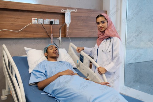 A Saudi female doctor wears a medical uniform and is examining and applying a nutrient solution, medicine and health care