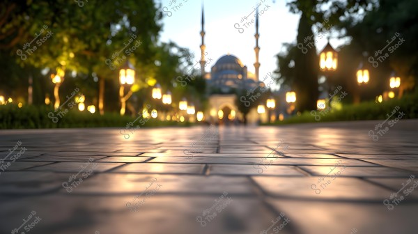Image of a large mosque in the background with two tall minarets, surrounded by trees and illuminated lamps. The ground in the foreground is paved with tiles, reflecting the soft light from the lamps scattered along the path.
