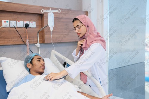 A Saudi female doctor wears a medical uniform and is examining and applying a nutrient solution, medicine and health care