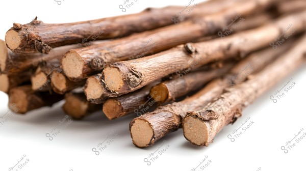 A collection of licorice sticks placed together. The sticks are light brown with a rough texture and smooth circular cross-sections. The image focuses on the natural details of the sticks.