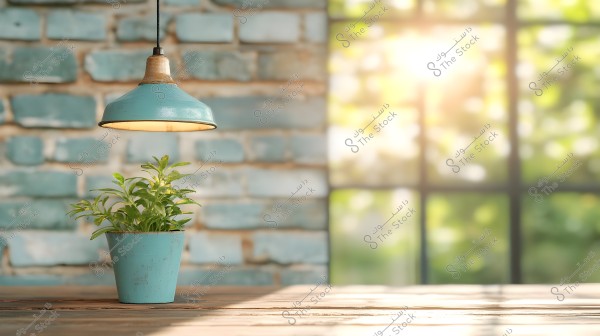 An image of a small light blue clay plant pot holding green plants, placed on a wooden table. Above it, a hanging blue metal lamp provides warm lighting. In the background, there is a light blue brick wall and sunlight filtering through a window, creating a natural and cozy atmosphere.