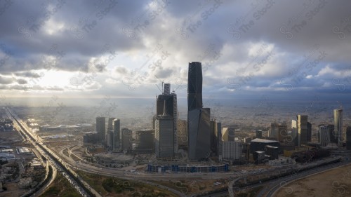 An aerial shot of the towers of the King Abdullah Financial District, showing the buildings and landmarks of the city of Riyadh in the daytime at sunset.