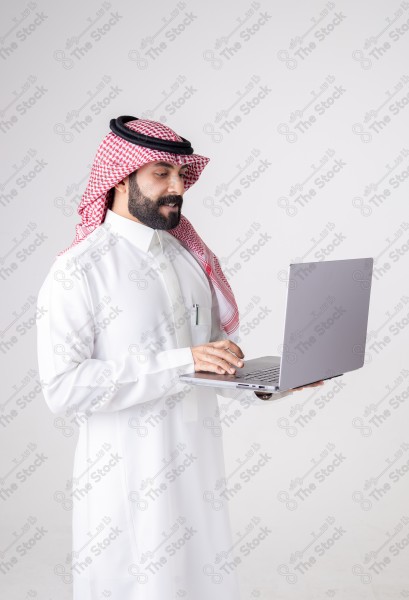 Portrait of a Saudi man holding a laptop and making different expressions, customer service, and communication.