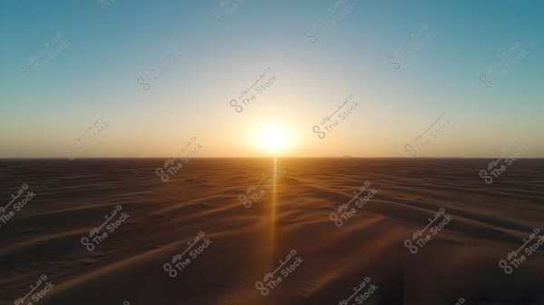 An image depicting a serene desert scene during sunset. A large sun is visible on the horizon, casting golden rays over the soft sand dunes. The sky transitions from light blue to shades of orange and yellow, creating a peaceful and tranquil atmosphere to the overall view.