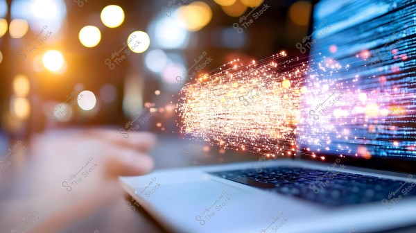 Image of an open laptop displaying code on the screen with bright streaks emanating, symbolizing data or digital connectivity. These streaks extend outward from the screen, displaying the vibrant flow of technology. The background is blurred with bokeh light effects.