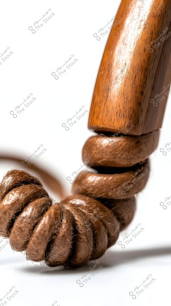 Close-up image of a wooden piece with part of a rope twisted around it. The texture and warm colors of the wood and rope are clearly visible, reflecting the beauty of natural materials.