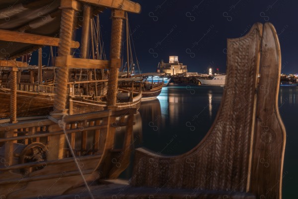 A shot of boats on the Arabian Gulf at night in Qatar, tourism in Qatar, tourist waterfront in Qatar.