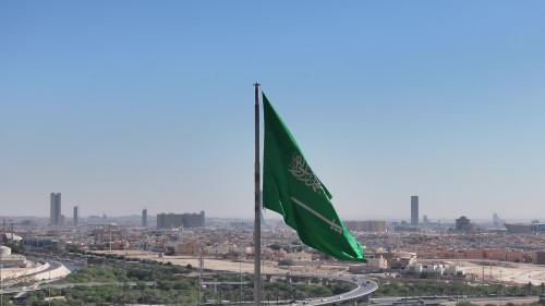 The video depicts scenes of Riyadh on a clear day, with the Saudi flag waving in the foreground, and the skyline showcasing famous buildings and modern architectural landmarks in the background.\r\n\r\n-