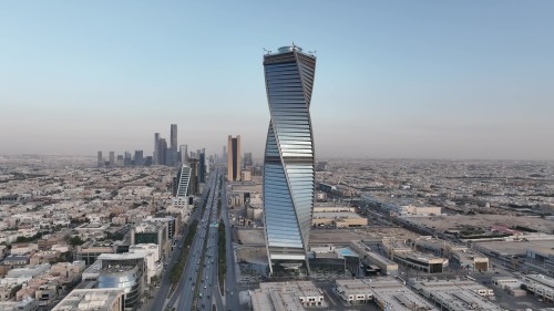 Aerial video of a major city showcasing modern skyscrapers and iconic towers, with a panoramic view of city streets and surrounding buildings in broad daylight.\r\n\r\n-